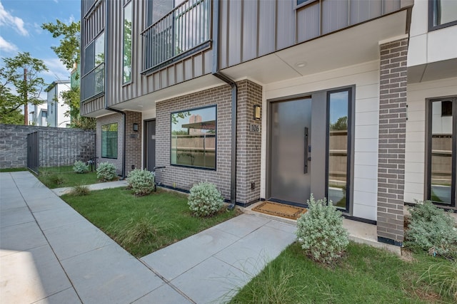 4517 Munger Ave Unit 106, Dallas, TX 75204 - doorway to property with brick siding, board and batten siding, and a balcony