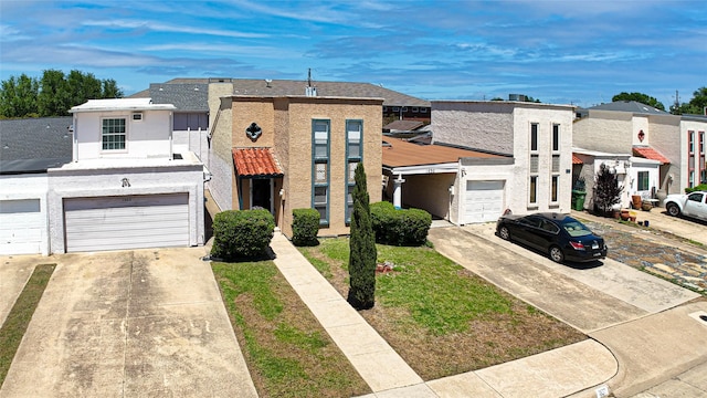 view of front of house with a garage, stucco siding, driveway, and a residential view