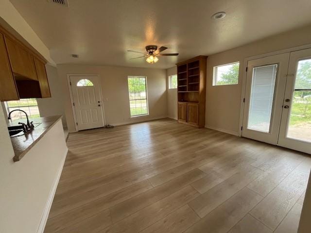610 N Pecan St, Hico, TX 76457 - interior space with plenty of natural light, baseboards, light wood-type flooring, french doors, and a ceiling fan
