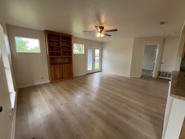 610 N Pecan St, Hico, TX 76457 - unfurnished living room featuring baseboards, light wood-type flooring, visible vents, and a ceiling fan