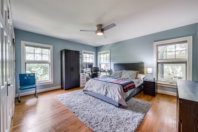 1580 Stemmons Ave, Dallas, TX 75208 - bedroom featuring wood finished floors, baseboards, a desk, and a ceiling fan