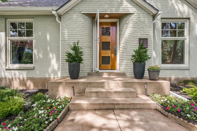 1580 Stemmons Ave, Dallas, TX 75208 - doorway to property featuring brick siding and roof with shingles