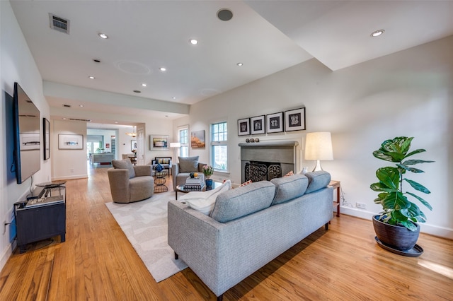 1580 Stemmons Ave, Dallas, TX 75208 - living area featuring light wood-style floors, a fireplace, baseboards, and recessed lighting