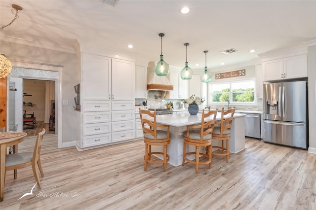 kitchen featuring stainless steel appliances, tasteful backsplash, visible vents, white cabinetry, and light countertops