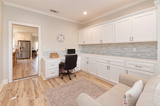 home office with recessed lighting, light wood-style floors, built in desk, visible vents, and crown molding