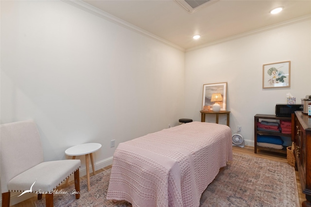 bedroom featuring baseboards, recessed lighting, wood finished floors, and crown molding