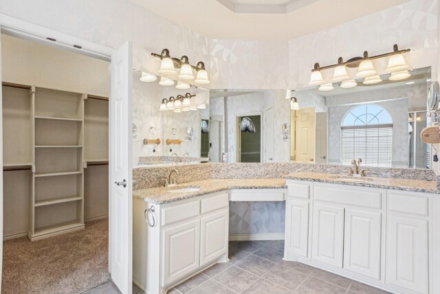 full bath featuring tile patterned flooring, double vanity, and a sink