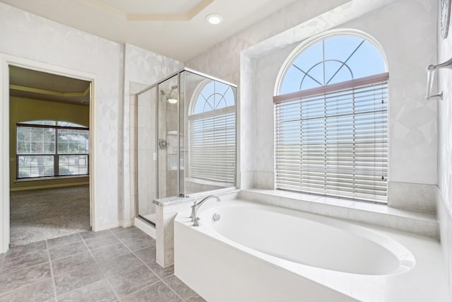 full bath with a bath, recessed lighting, a shower stall, and baseboards