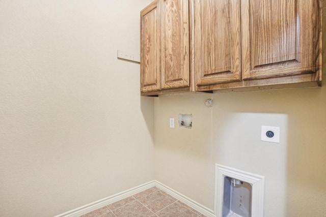laundry room featuring cabinet space, light tile patterned floors, electric dryer hookup, hookup for a washing machine, and baseboards