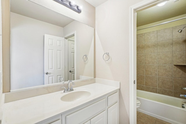 bathroom featuring toilet, tile patterned flooring, shower / bath combination, and vanity