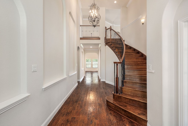 141 Claremont Dr, Ovilla, TX 75154 - entryway with arched walkways, wood finished floors, a chandelier, stairs, and a towering ceiling