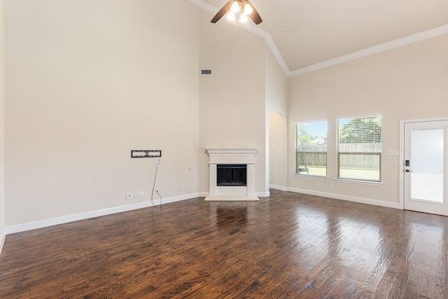 141 Claremont Dr, Ovilla, TX 75154 - unfurnished living room with crown molding, high vaulted ceiling, a fireplace with raised hearth, ceiling fan, and dark wood-type flooring