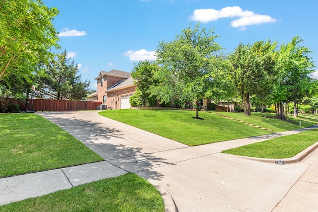 141 Claremont Dr, Ovilla, TX 75154 - obstructed view of property featuring concrete driveway, an attached garage, brick siding, and central AC unit