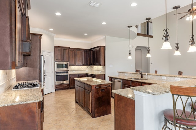 141 Claremont Dr, Ovilla, TX 75154 - kitchen featuring stainless steel appliances, backsplash, a sink, arched walkways, and a ceiling fan