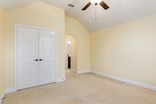 141 Claremont Dr, Ovilla, TX 75154 - unfurnished bedroom with light colored carpet, lofted ceiling, arched walkways, a closet, and baseboards