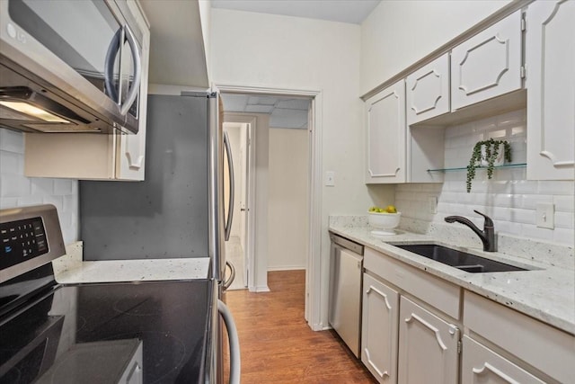 4312 Bellaire Dr S Unit 141, Fort Worth, TX 76109 - kitchen with light stone counters, tasteful backsplash, a sink, stainless steel appliances, and wood finished floors