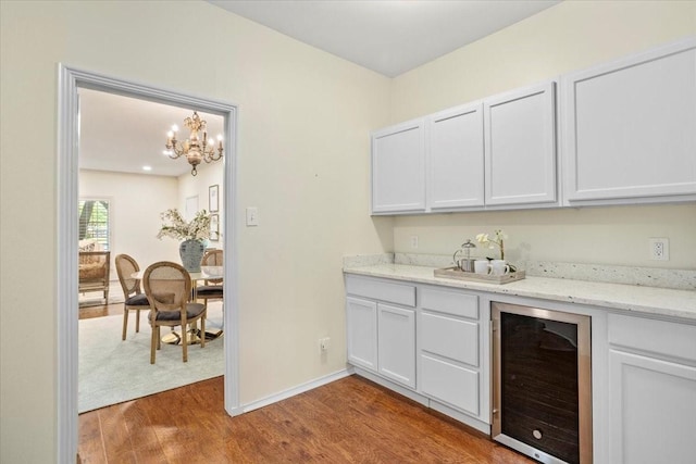 4312 Bellaire Dr S Unit 141, Fort Worth, TX 76109 - bar featuring beverage cooler, wood finished floors, baseboards, a notable chandelier, and a dry bar