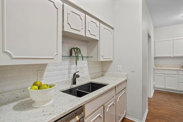 4312 Bellaire Dr S Unit 141, Fort Worth, TX 76109 - kitchen featuring light stone counters, white cabinetry, decorative backsplash, a sink, and dark wood-type flooring
