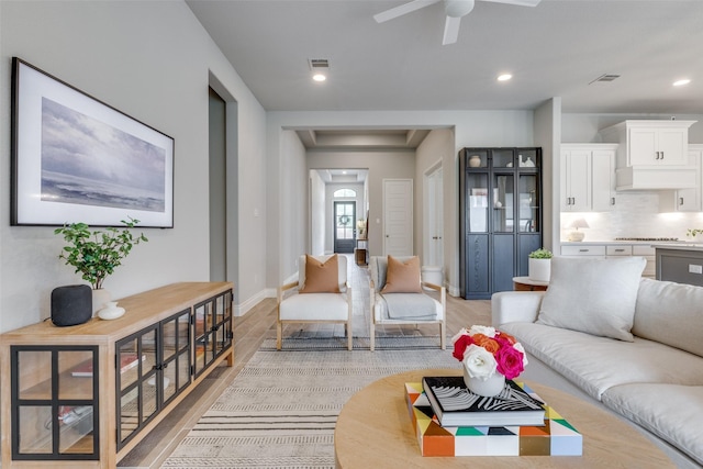 living room with baseboards, visible vents, a ceiling fan, and recessed lighting