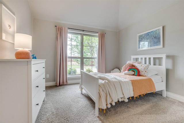 bedroom featuring baseboards, lofted ceiling, and light colored carpet