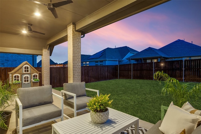 4009 Palomino Rd, Aubrey, TX 76227 - patio terrace at dusk with a ceiling fan and an outdoor hangout area