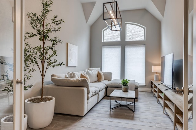living area featuring light wood-type flooring and vaulted ceiling