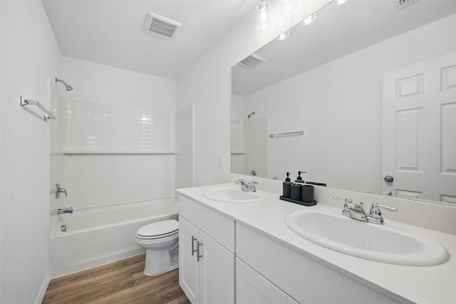 849 Breakwater Dr, Princeton, TX 75407 - full bathroom featuring visible vents, wood finished floors, toilet, and a sink