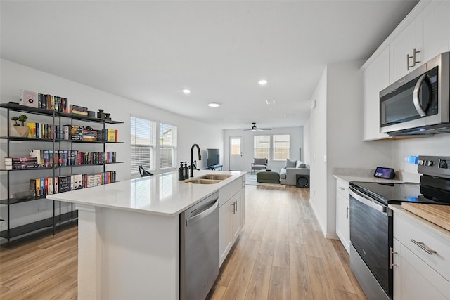 849 Breakwater Dr, Princeton, TX 75407 - kitchen with light wood-type flooring, appliances with stainless steel finishes, light countertops, and a sink