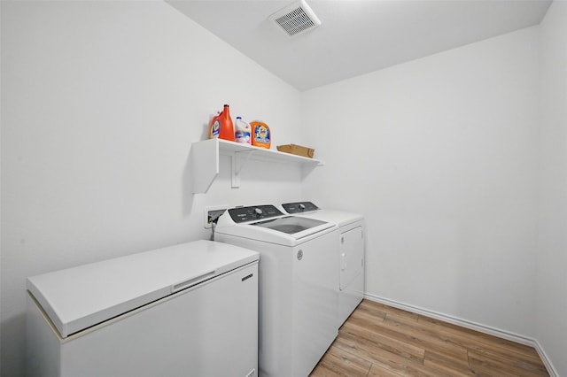 849 Breakwater Dr, Princeton, TX 75407 - laundry area with washing machine and clothes dryer, laundry area, visible vents, light wood-style flooring, and baseboards
