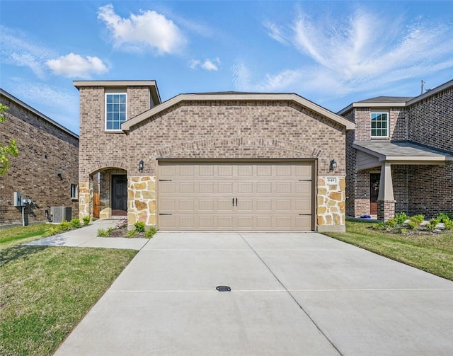 849 Breakwater Dr, Princeton, TX 75407 - view of front of home featuring stone siding, concrete driveway, brick siding, and a garage