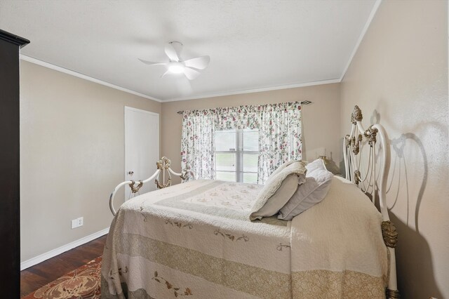 bedroom featuring baseboards, ornamental molding, a ceiling fan, and dark wood-type flooring