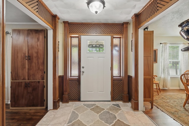 entryway with wood finished floors