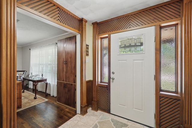 entryway featuring plenty of natural light and ornamental molding