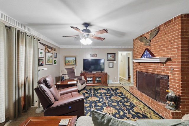 carpeted living room featuring a brick fireplace, crown molding, and ceiling fan