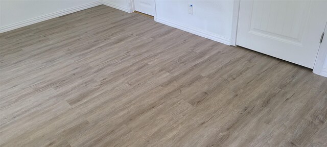 room details with baseboards and wood finished floors