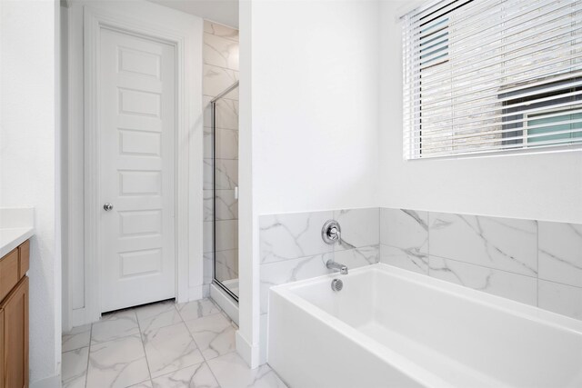 full bath with a bath, marble finish floor, vanity, and a stall shower
