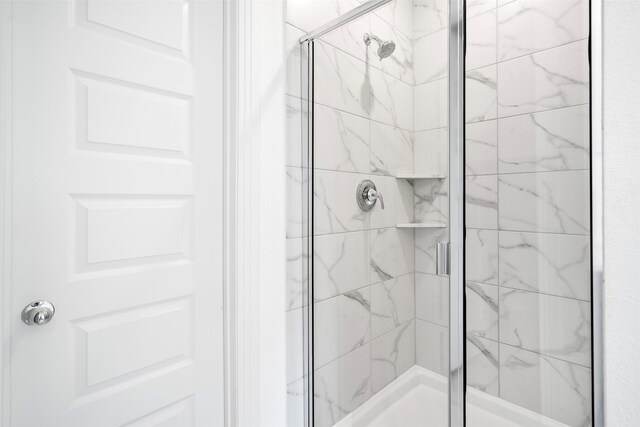 bathroom featuring a shower stall