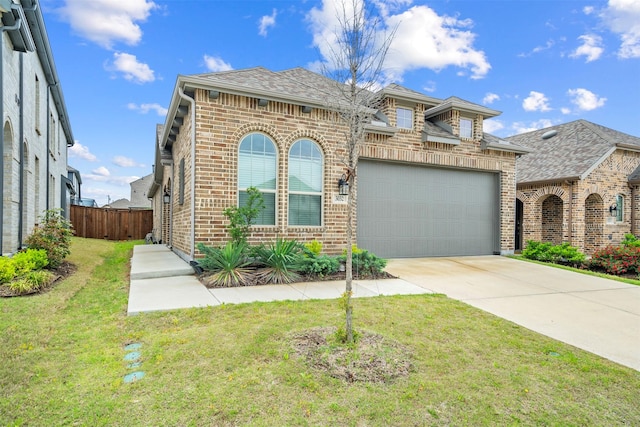 view of front of property with driveway, an attached garage, fence, brick siding, and a front lawn