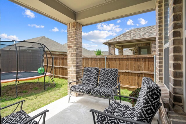 view of patio / terrace with a trampoline and a fenced backyard