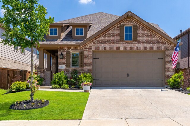 view of front of house with driveway, an attached garage, fence, brick siding, and a front lawn