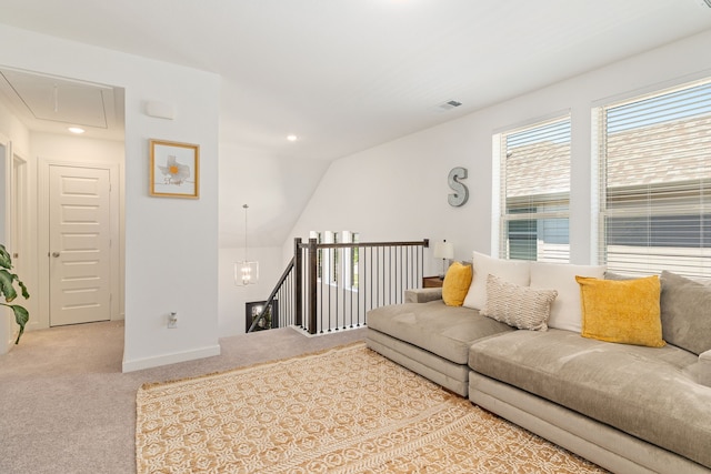 carpeted living area with baseboards, visible vents, attic access, and recessed lighting