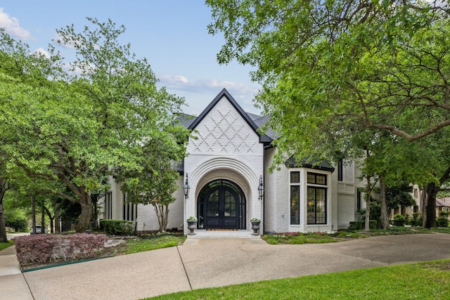 view of front facade featuring french doors and brick siding