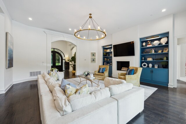 living room featuring visible vents, arched walkways, a notable chandelier, recessed lighting, and dark wood-type flooring