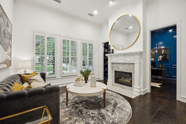 living room with a fireplace, recessed lighting, wood finished floors, visible vents, and ornamental molding