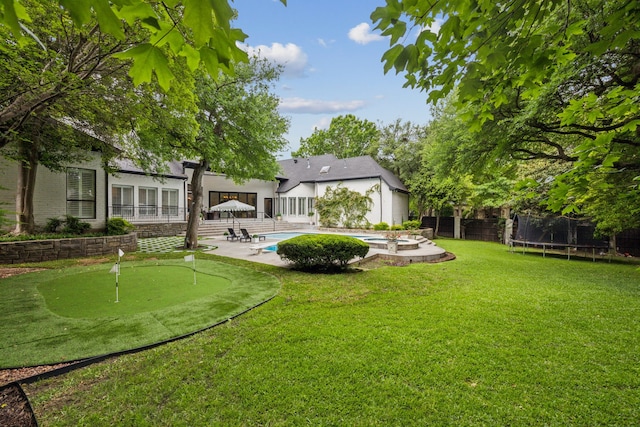 6625 Overlook Ct, Plano, TX 75024 - back of property with a yard, a pool with connected hot tub, a chimney, and a sunroom
