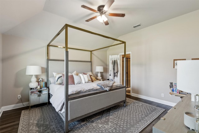 bedroom featuring visible vents, vaulted ceiling, wood finished floors, and baseboards