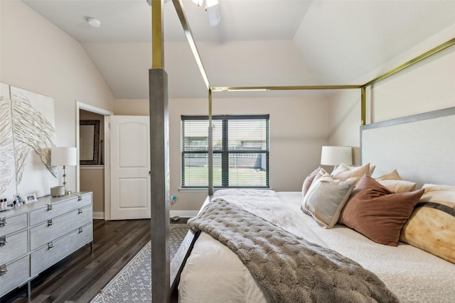 bedroom with dark wood-style flooring, vaulted ceiling, and baseboards