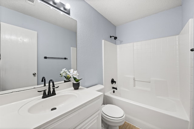 full bathroom with vanity, toilet, a textured ceiling, shower / washtub combination, and wood finished floors