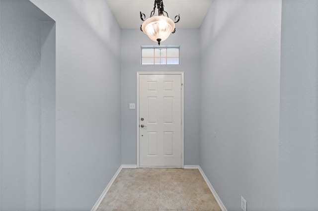 doorway featuring baseboards