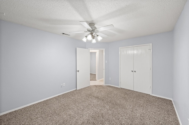 unfurnished bedroom featuring visible vents, baseboards, carpet flooring, and a closet